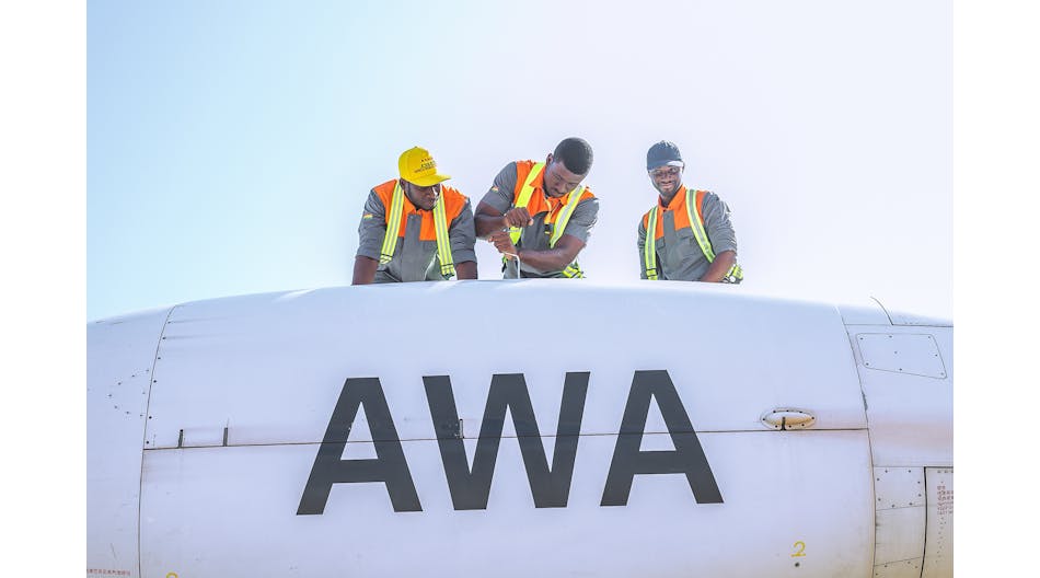 Africa World Airways technicians finishing a maintenance task on left engine.