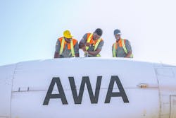Africa World Airways technicians finishing a maintenance task on left engine. Africa World Airways technicians finishing a maintenance task on left engine.