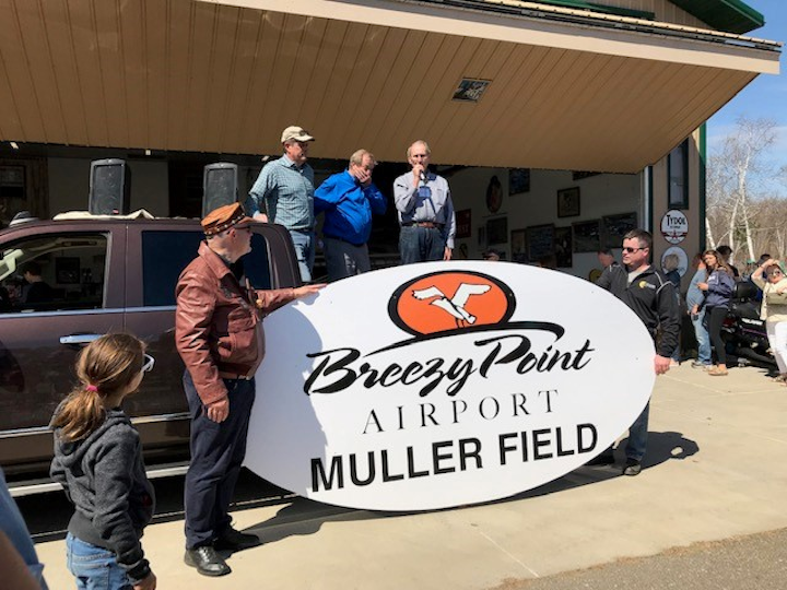 Jeff Smith, Cliff Muller, Mayor Tom Lillehei and Cliff Muller in front of new sign.