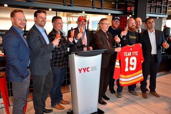 Representatives celebrate YYC&rsquo;s Domestic Terminal dining refresh and the grand opening of The Burger Federation.