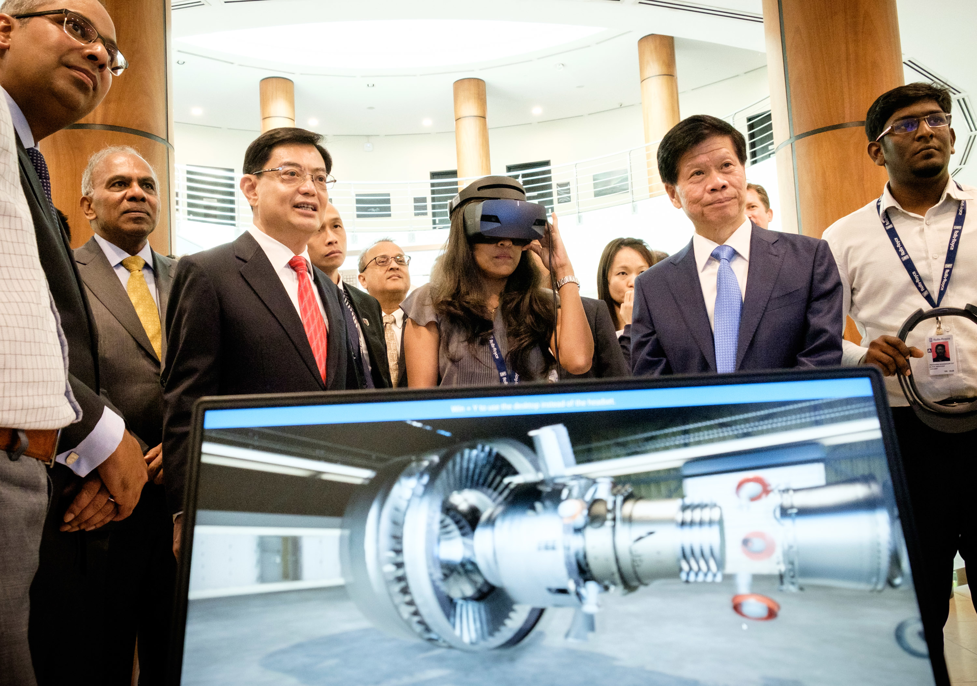 NTU President Subra Suresh and Singapore's Deputy Prime Minister and Minister for Finance Mr Heng Swee Keat (pictured second and third from left) viewing a demonstration on engine design using artificial intelligence and virtual reality technologies developed by the Rolls-Royce@NTU Corp Lab