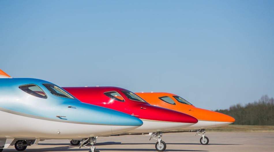 The HondaJet Elite in Ice Blue, Ruby Red and Monarch Orange at Honda Aircraft Company&apos;s headquarters in Greensboro, NC.