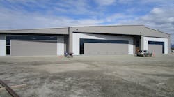 This Lake Hood Anchorage, Alaska hangar has two bifold doors and a hydraulic door at its center. The decorative window design really sets it off from other hangars.