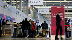 Travelers move through the ticketing area of Delta Air Lines in terminal 2 at O'Hare International Airport in Chicago on Tuesday, Jan. 12, 2016.