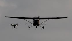 A drone is shown encroaching on a small aircraft in flight. Photo courtesy of A drone is shown encroaching on a small aircraft in flight. A drone is shown encroaching on a small aircraft in flight. Photo courtesy of A drone is shown encroaching on a small aircraft in flight.