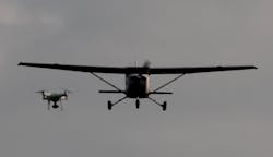 A drone is shown encroaching on a small aircraft in flight. Photo courtesy of A drone is shown encroaching on a small aircraft in flight.