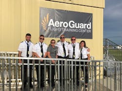 The Florida team and their students celebrate the opening of AeroGuard&apos;s newest campus. Pictured from left to right are: Nik Kaszuba, Max Silva, Debbie Ederer, Mark Pysher, Pierre Cieciorko, Sydney Zhang