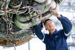 A technician working on an engine at Executive Haite Aviation Services China.