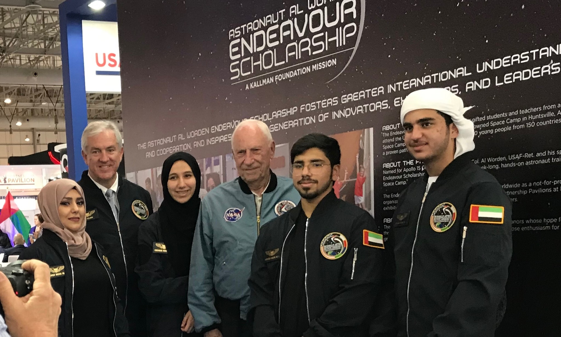 Endeavour Scholarship winners and leaders at the Dubai Airshow 2019 (l to r): Educator Rasha Abou Arkoub, Kallman Foundation President and CEO Tom Kallman, student Alanood Abdulla Al Hajri, Apollo 15 CMP Al Worden, students Omran Rahma Orman Ali Al Shamsi and Mohammed Humaid Aldhaheri. Not pictured: Student Saif Baha Al Badawna and educator Ghaleb Awad Wahbi.