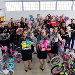 The American Aero team and members of the U.S. Marine Corps Reserve show off gifts collected at the FBO&apos;s annual Toys for Tots holiday toy drive. Since opening its doors in 2013, the FBO at Meacham International Airport in Fort Worth has purchased 600 bicycles and helped gather 1,400 children&rsquo;s gifts. This year, the FBO will deliver 50 bicycles and more than 200 toys and games to Toys for Tots.