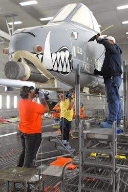 Anthony Montanez, Dennis Reeves and Brady Ringel, 576th Aircraft Maintenance Squadron technicians, prepare the first production A-10 Thunderbolt II for paint removal using a new robotic media blast technology Dec. 4, 2019, at Hill Air Force Base, Utah. The corrosion control technicians seal up the seams and holes in the outer-surface skin to prevent the blast media from entering the aircraft. Anthony Montanez, Dennis Reeves and Brady Ringel, 576th Aircraft Maintenance Squadron technicians, prepare the first production A-10 Thunderbolt II for paint removal using a new robotic media blast technology Dec. 4, 2019, at Hill Air Force Base, Utah. The corrosion control technicians seal up the seams and holes in the outer-surface skin to prevent the blast media from entering the aircraft.