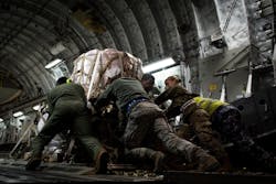 Members of the 99th Logistics Readiness Squadron and the Royal Australian Air Force push a pallet of fire suppressant up the ramp of an Australian C-17 Globemaster III, Jan. 16, 2020 at Nellis Air Force Base, Nev. Airmen from the United States and Australian Air Forces worked together to load the aircraft with the cargo to be delivered to Australia for aid in wildfire relief. Members of the 99th Logistics Readiness Squadron and the Royal Australian Air Force push a pallet of fire suppressant up the ramp of an Australian C-17 Globemaster III, Jan. 16, 2020 at Nellis Air Force Base, Nev. Airmen from the United States and Australian Air Forces worked together to load the aircraft with the cargo to be delivered to Australia for aid in wildfire relief.