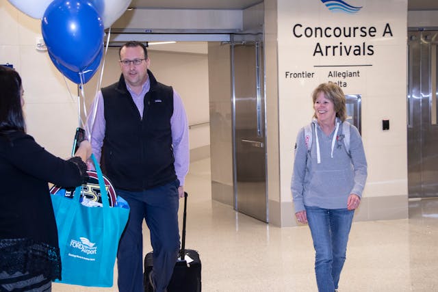 Delta Air Lines passenger Keith O&rsquo;Brien (left), and Southwest passenger Karen Burleson, were surprised as the &ldquo;GRRand Passengers&rdquo; as the Ford Airport celebrated its record-setting 2019