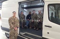 Airmen from the 92nd Logistics Readiness Squadron pose with an upgraded transit van at Fairchild Air Force Base, Wash., March 5, 2020. The 92nd Mission Support Group and 92nd Maintenance Group collaborated to modify the vehicle to improve convenience, safety and efficiency.