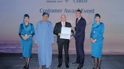 Mohammed Al Musafir, SVP Commercial Cargo of Oman Air (left), and Paul Robert Starrs, Chief Commercial Officer of Oman Air (right), present the award to Thomas Sonntag, CEO of Jettainer GmbH.