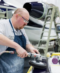 At work in Elliott Aviation's paint shop. At work in Elliott Aviation's paint shop.