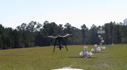 The eagle has landed! Eagle XF drone by SOLUTE, carrying a camera, lands after finishing the NIST test course (white buckets on stands) in Camp Shelby, Mississippi.