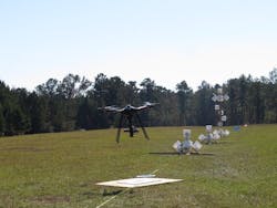 The eagle has landed! Eagle XF drone by SOLUTE, carrying a camera, lands after finishing the NIST test course (white buckets on stands) in Camp Shelby, Mississippi.