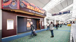 A PDX passenger stops to admire the Hollywood Theatre's marquee.