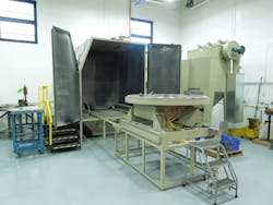 MB Aerospace uses its modified ZERO BNP-7212 abrasive-blasting cabinet to clean ground turbine components before inspecting them for cracks and wear. The components are secured on a 66&rdquo; rotating turntable.