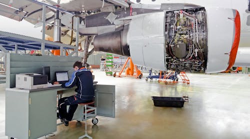 Aircraft Maintenance Technician At A Workstation In A Maintenance Hangar 5e7cdf9f54c8c