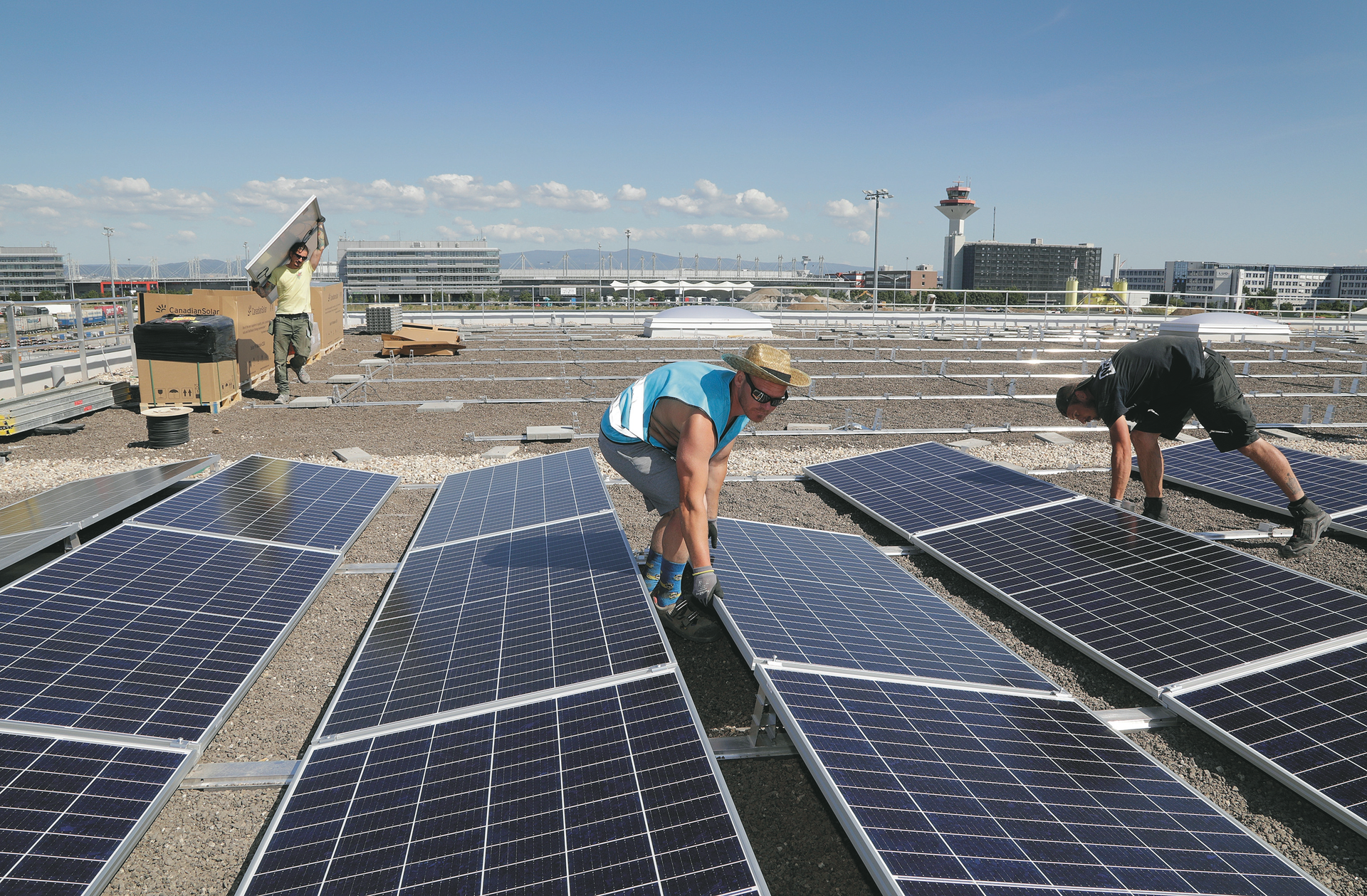 Large photovoltaic system in construction on cargo hall at Frankfurt Airport.