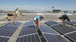 Large photovoltaic system in construction on cargo hall at Frankfurt Airport.