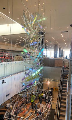 Comprised of roughly 300 dichroic glass panels, and 220 hand drawn glass and Pyrex rods, this 65-foot-tall suspended sculpture cascades down the escalator well at the entrance to the new main termina Comprised of roughly 300 dichroic glass panels, and 220 hand drawn glass and Pyrex rods, this 65-foot-tall suspended sculpture cascades down the escalator well at the entrance to the new main termina