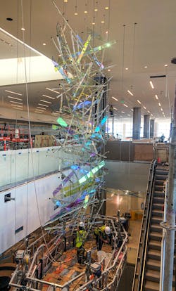 Comprised of roughly 300 dichroic glass panels, and 220 hand drawn glass and Pyrex rods, this 65-foot-tall suspended sculpture cascades down the escalator well at the entrance to the new main termina
