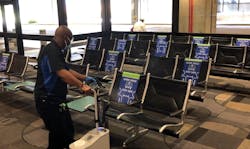 A TPA employee uses an electrostatic sprayer to disinfect the airport's seating. A TPA employee uses an electrostatic sprayer to disinfect the airport's seating.