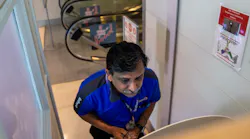 Southwest Airlines customer service supervisor Arshad Khan goes through a temperature check at a Wello temperature check kiosk at an employee screening station at Dallas Love Field.