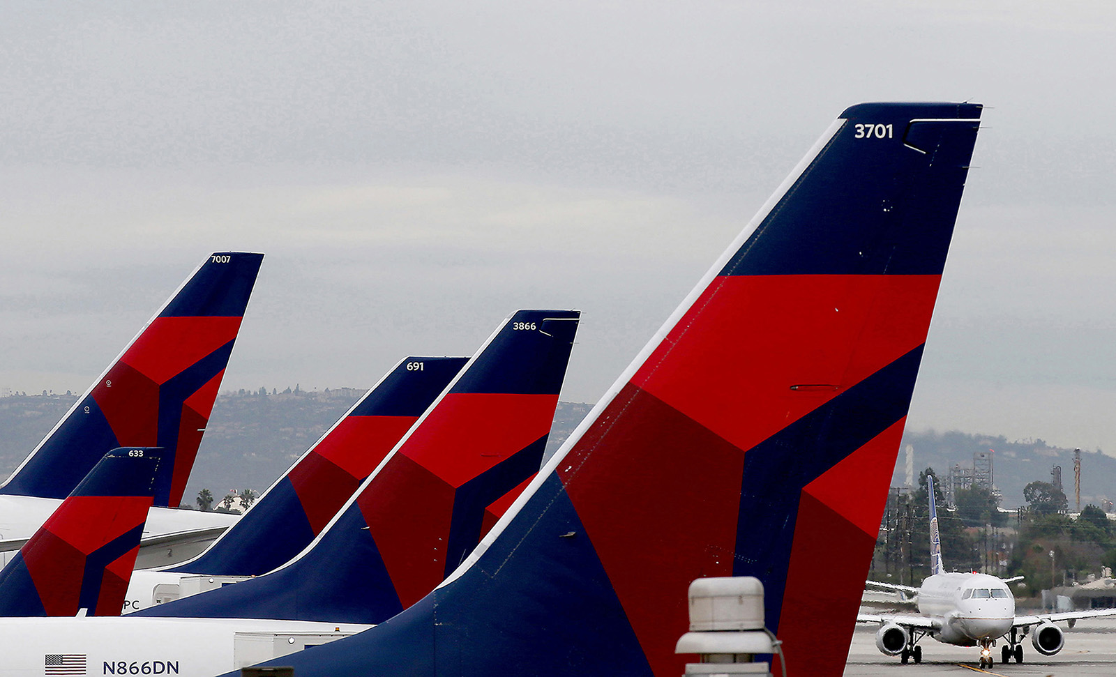 Delta Airlines aircraft are lined up at Terminal 5 in Los Angeles International Airport on Dec. 21, 2016. Delta has overhauled how it cleans airplanes and operates at airports to attract people back to flying.