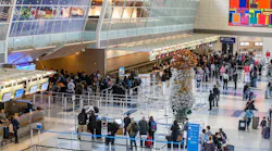 Four days before Christmas in 2019, travelers wait through long security lines at DFW International Airport's Terminal D.