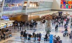 Four days before Christmas in 2019, travelers wait through long security lines at DFW International Airport's Terminal D. Four days before Christmas in 2019, travelers wait through long security lines at DFW International Airport's Terminal D.