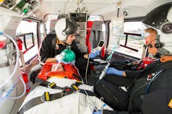 A patient in transport receives care. A patient in transport receives care.