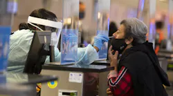 During the global coronavirus pandemic Ana Ramos, right, is being tested for covid19 in Tom Bradley international at LAX on Tuesday, Nov. 17, 2020 in Los Angeles, CA. (Francine Orr/ Los Angeles/TNS)
