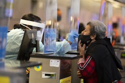 During the global coronavirus pandemic Ana Ramos, right, is being tested for covid19 in Tom Bradley international at LAX on Tuesday, Nov. 17, 2020 in Los Angeles, CA. (Francine Orr/ Los Angeles/TNS)