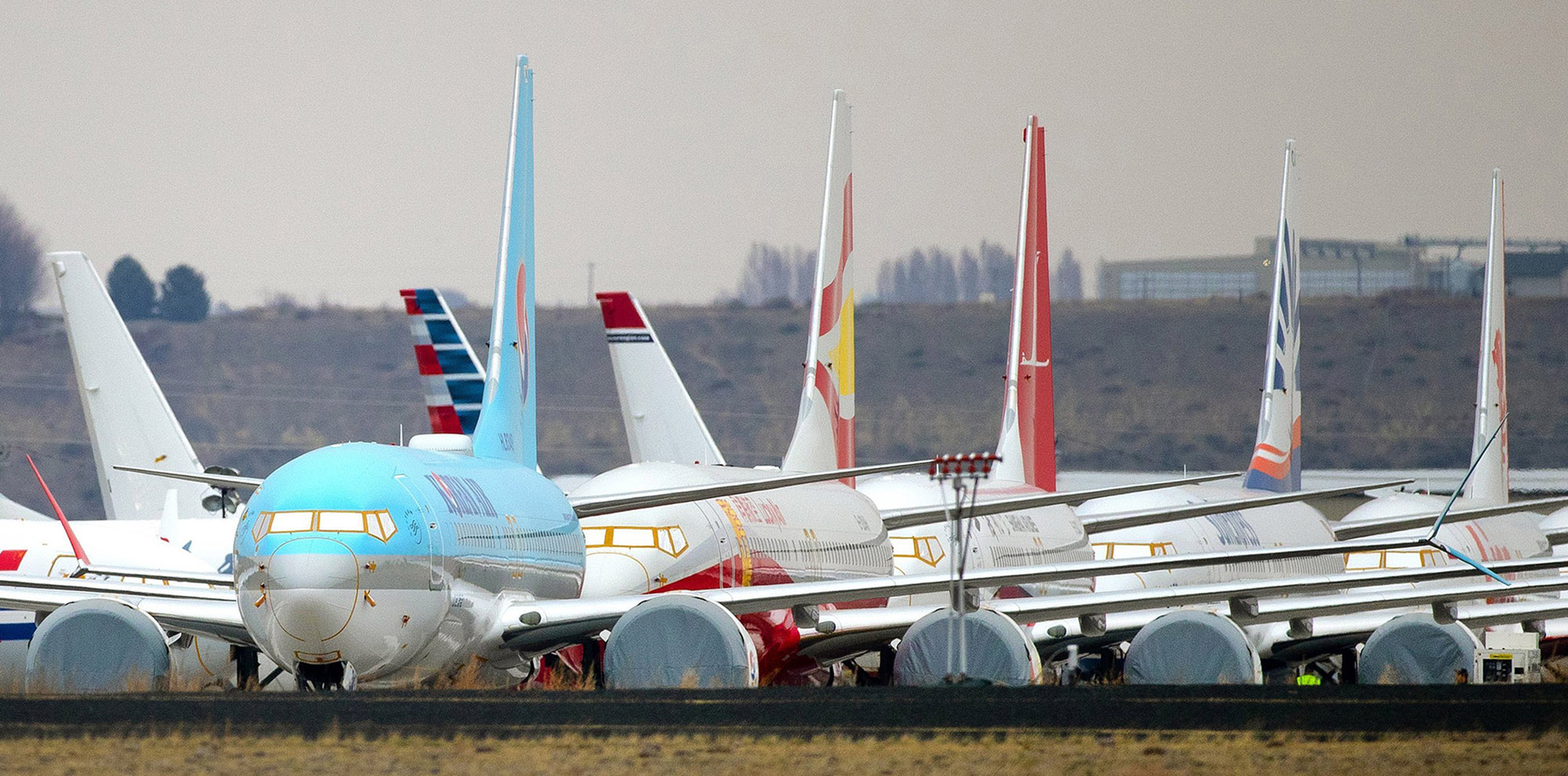 Some of the hundreds of completed Boeing 737 MAX planes destined for airlines worldwide are parked at an airport in Moses Lake, Washington in November 2019. Boeing on Tuesday delivered its first 737 MAX in 21 months, the first since the Federal Aviation Administration ungrounded the jet last month.