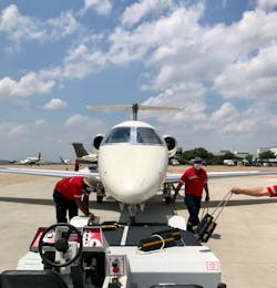 TAC Air-DAL workers securing the nose wheel for tow. TAC Air-DAL workers securing the nose wheel for tow.