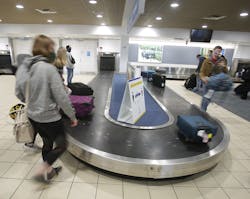 Passengers grab their luggage at Akron - Canton Airport after arriving from Charlotte, North Carolina, in late December. Passengers grab their luggage at Akron - Canton Airport after arriving from Charlotte, North Carolina, in late December.
