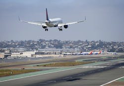 A Delta Airlines jet approaches San Diego International Airport for a landing after flying from Atlanta on August 29, 2019