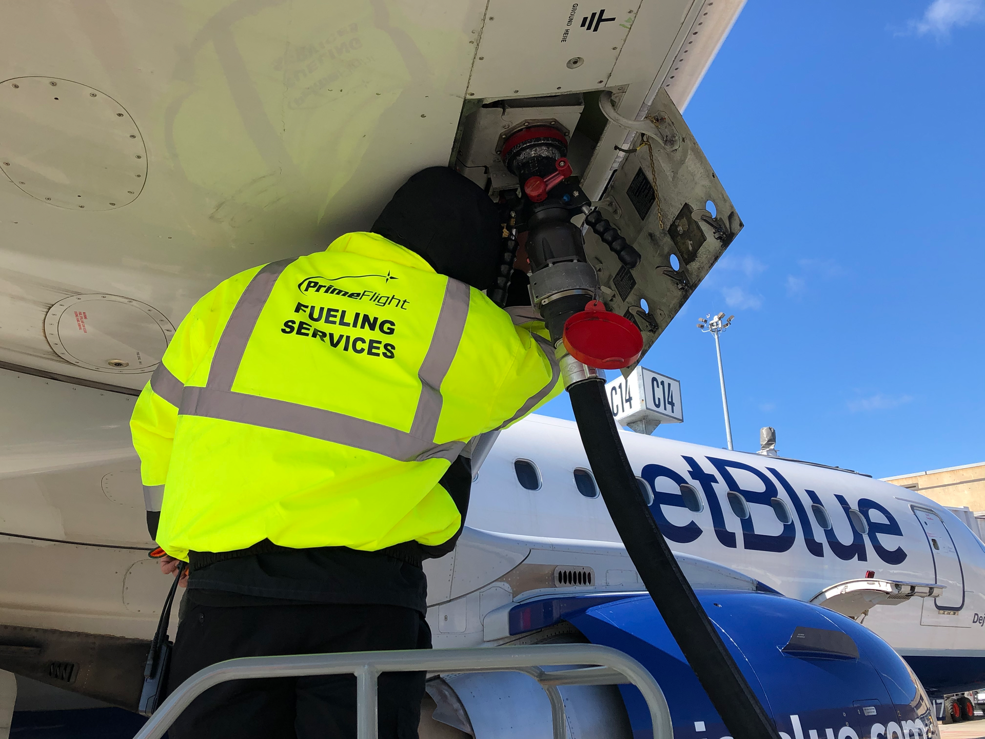 A PrimeFlight employee sporting a high visibility jacket.