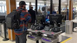 A TSA officer checks a traveler&rsquo;s ID with the credential authentication technology unit at Appleton International Airport.
