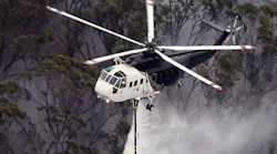 A Sikorsky S 61 Helicopter Performs A Water Drop During An Aerial Firefighting Mission