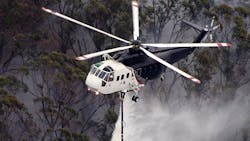 A Sikorsky S 61 Helicopter Performs A Water Drop During An Aerial Firefighting Mission
