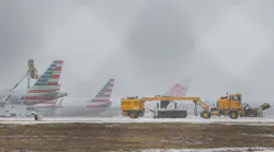 An American Airlines jets get inline to be de-iced at DFW International Airport before takeoff as winter flurries arrive in Irving on Sunday, February 14, 2021 ahead of major snowstorm.