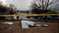 Residents take pictures of debris fallen from a United Airlines airplane's engine in the neighborhood of Broomfield, outside Denver, Colorado, on February 20, 2021 - A United Airlines flight suffered a fiery engine failure on February 20, shortly after taking off from Denver on its way to Hawaii, dropping massive debris on a residential area before a safe emergency landing, officials said.