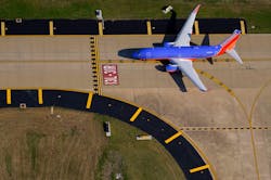 A Southwest Airlines 737-7H4 holds short of the 13L-31R runway at Dallas Love Field. A Southwest Airlines 737-7H4 holds short of the 13L-31R runway at Dallas Love Field.