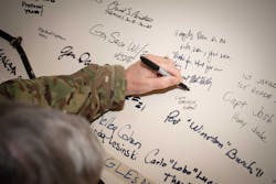 Army Gen. Mark A. Milley, chairman of the Joint Chiefs of Staff, signs a wall after writing &apos;every day there is no nuke war, you won. Thanks for what you are doing,&apos; during a tour of Minot Air Force Base, N.D., March 26, 2021.