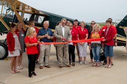 Guy Lieser, center, with Peter Limberger, left, cut the ribbon on the Janesville Jet Center in front of the 1929 Travel Air Model 10-D airplane. Guy Lieser, center, with Peter Limberger, left, cut the ribbon on the Janesville Jet Center in front of the 1929 Travel Air Model 10-D airplane.